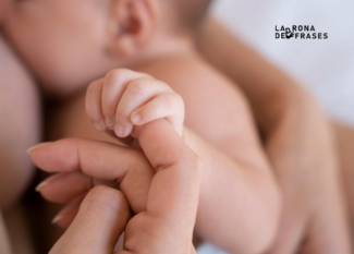 Primer plano de la mano de un bebé sosteniendo el dedo de su madre durante un momento de conexión